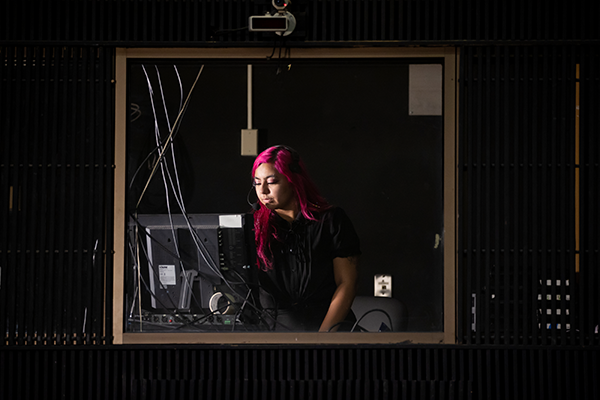 Isabel Peña working in the CSUSB Ronald E. Barnes Theatre.