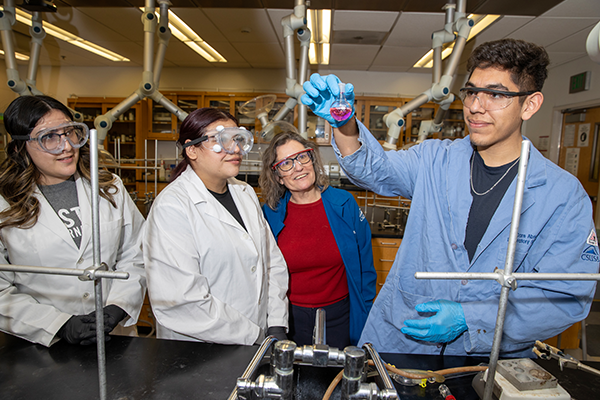 Cousins working with students in her lab.