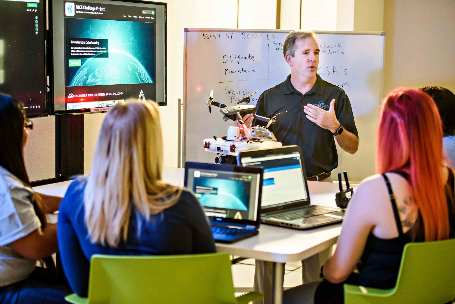 Tony Coulson, executive director of the CSUSB Cybersecurity Center, with some of his students. The National Security Agency selected the university to be a leader of its core workforce development initiative.