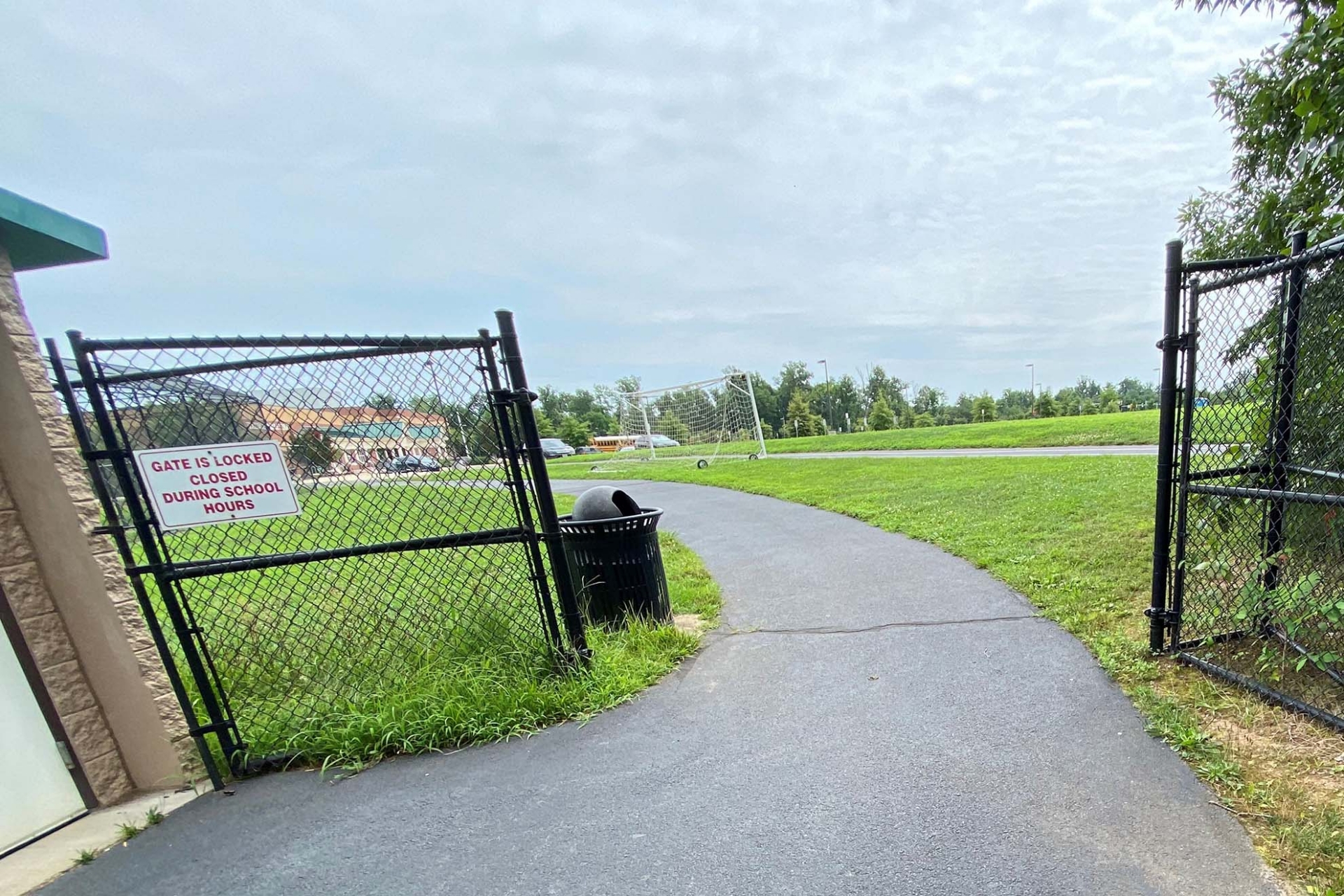 Photo of an open gate to a school yard.