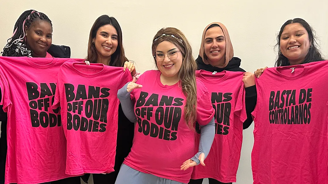 Members of the Intersectional Feminist Alliance, a new student-led organization at CSUSB that advocates for gender equity and women’s empowerment, display their club apparel.