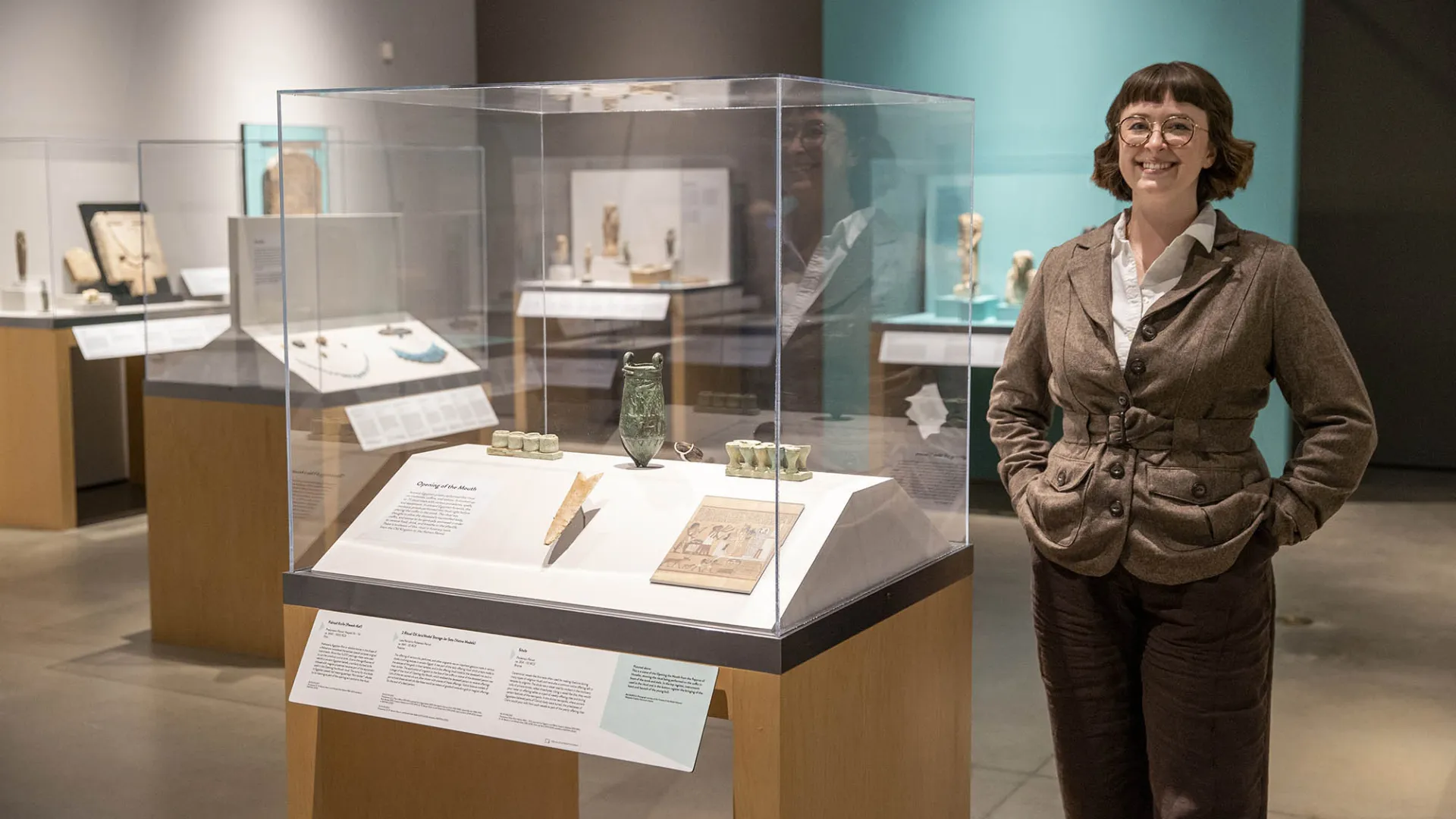 Emily Smith-Sangster among the Robert and Frances Fullerton Museum of Art’s collection of Ancient Egyptian artifacts.