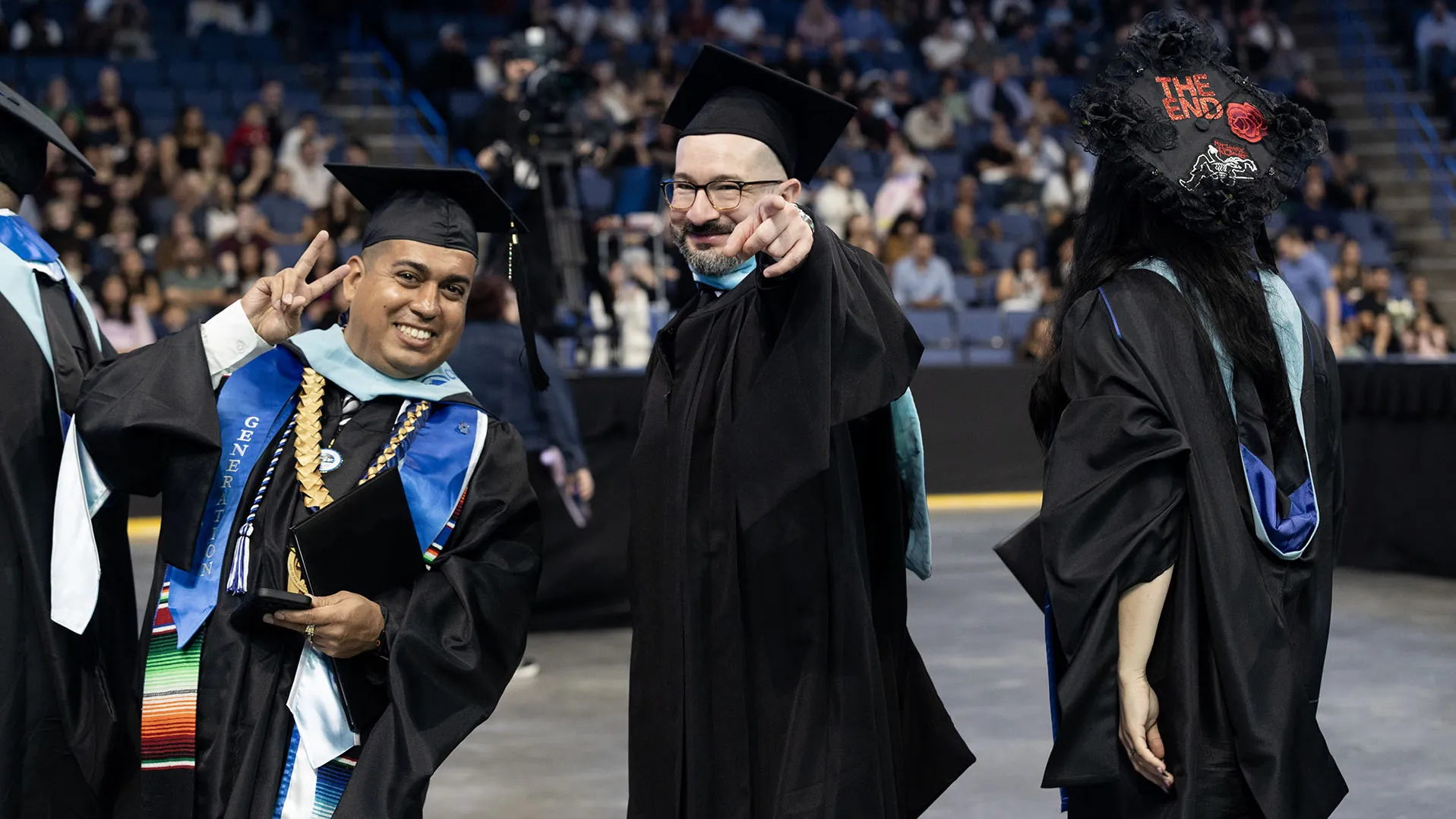 Two members of CSUSB’s Class of 2026 celebrate at the ceremony for the College of Arts and Letters and the James R. Watson and Judy Rodriguez Watson College of Education at Toyota Arena on May 16.