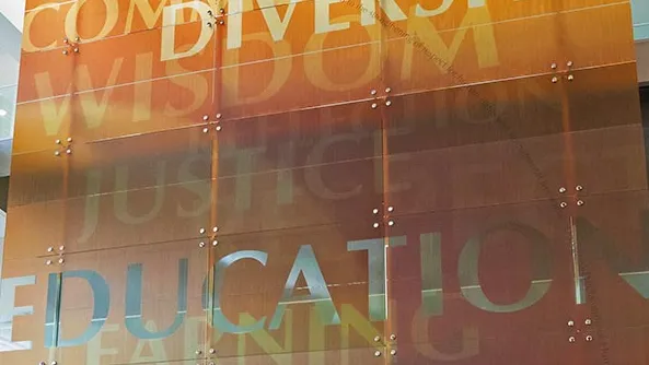 The mural hanging in the CSUSB College of Education building atrium.