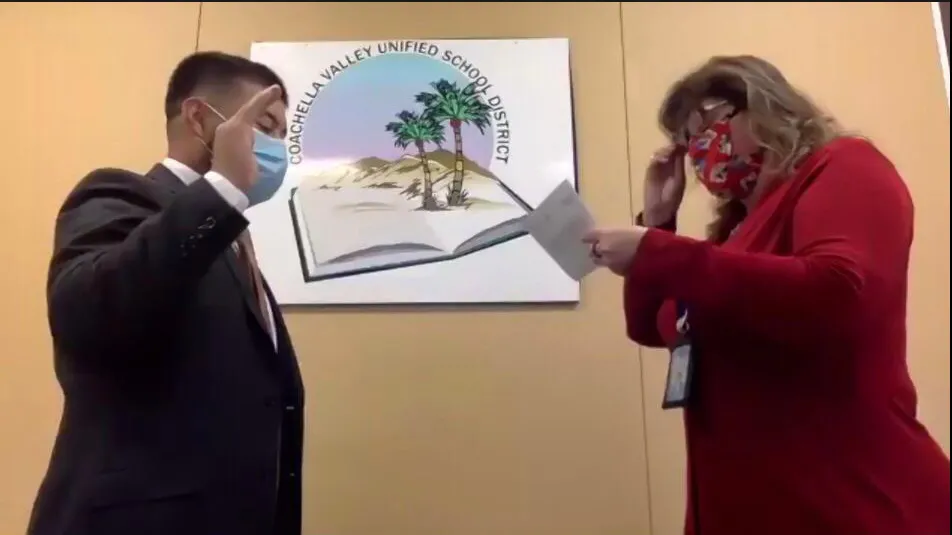CSUSB alumnus Adonis Galarza-Toledo (left) is sworn in as a member of the board of the Coachella Valley Unified School District.