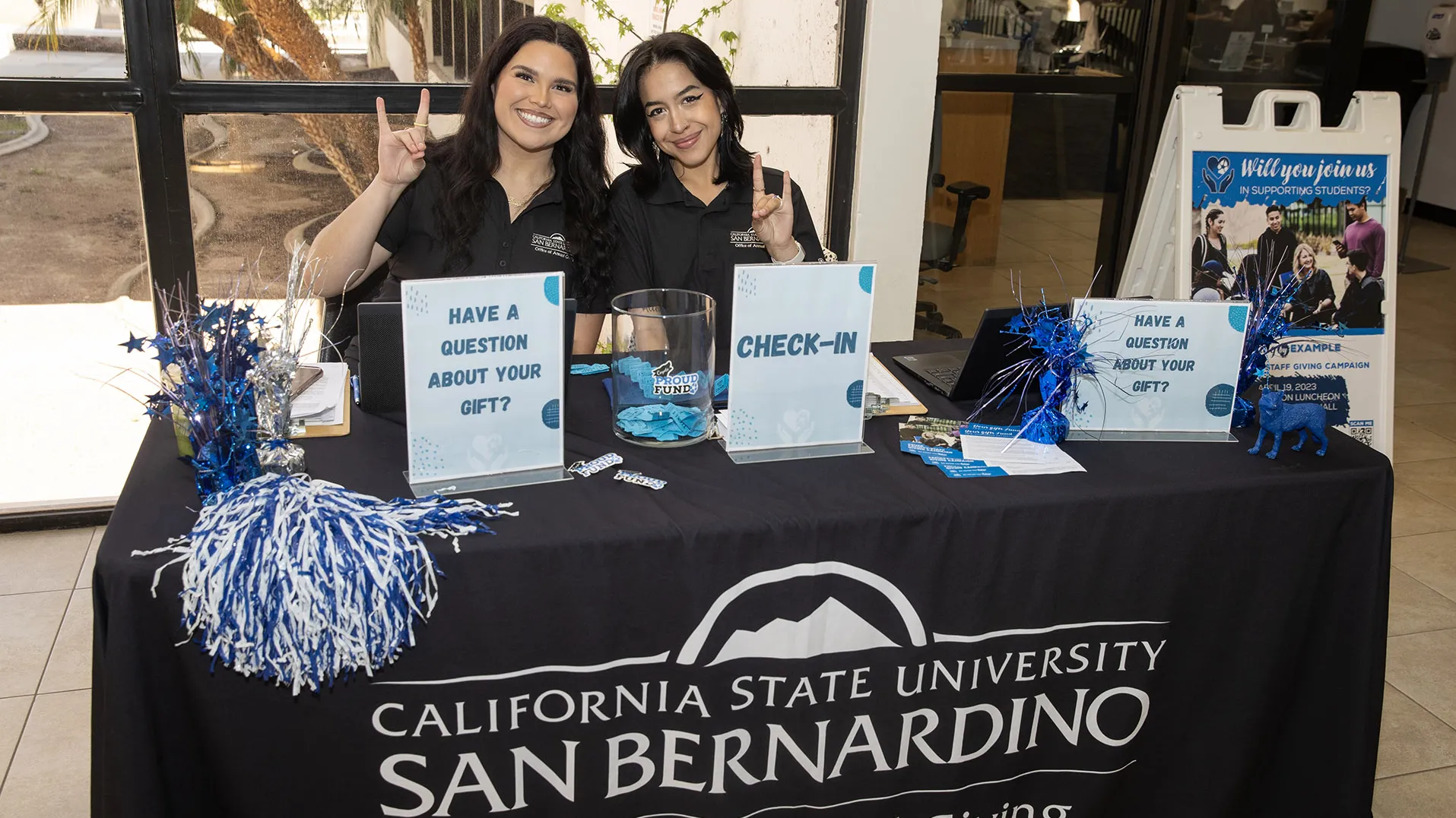 Two students at the sign-in desk for the event.