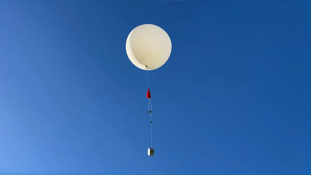An ozonesonde balloon rises into the sky above Cal State San Bernardino, part of the NASA/NOAA Aeromma airborne campaign to study pollution dynamics.