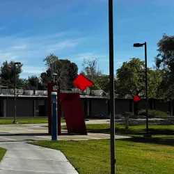 Red flags are displayed across the CSUSB campus.