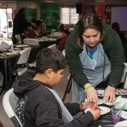 Coyote Cares Day 2023, CSUSB student Keida Velazquez, right, helps youth create art projects at the Akoma Unity Center in San Bernardino. 