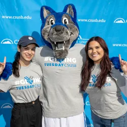 Cody Coyote with two CSUSB students 