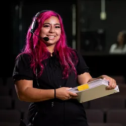 Isabel Peña working in the CSUSB Ronald E. Barnes Theatre.