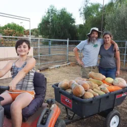 Becky Talyn (far right), a lecturer of biology, and Erik Melchiorre (center), a professor of geology, and their daughter, Gabrieila (seated)