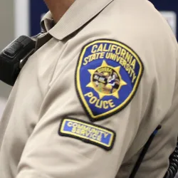 The UPD Community Service Officer patch on a uniform sleeve.