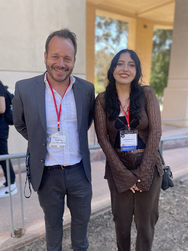 Ryan Keating, director of the Office of Student Research and professor of history, congratulates CSUSB student Annabella Garcia, who earned first place in the undergraduate Behavioral, Social Sciences and Public Administration category for her research project, “Changing Assumptions on Decorative Features of Defensive Technology in Experimental Archeology, Using Ichcahuipilli Armor.” 