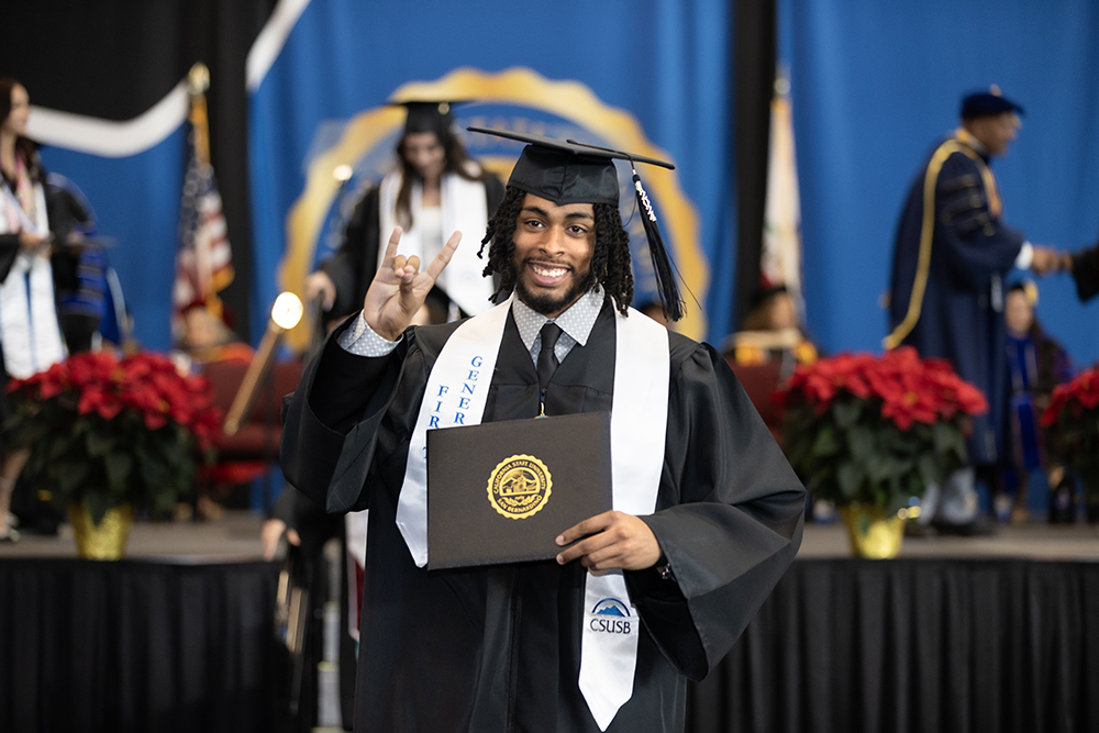 A graduate shows off his coyote pride at the College of Social and Behavioral Sciences Fall Commencement ceremony on Dec. 13.