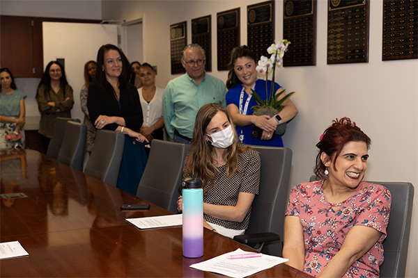 Manijee Badiee, on the right, surrounded by fellow faculty members, staff and administrators as she is honored with the 2023-24 Golden Apple Award.