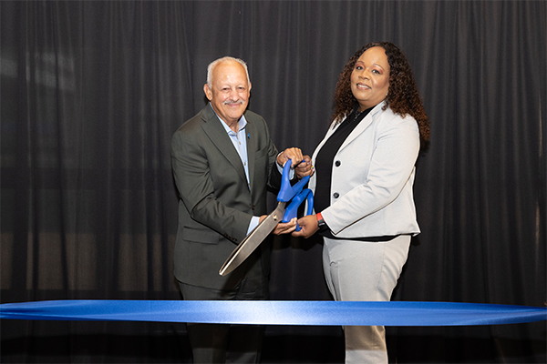 CSUSB President Tomás D. Morales and Robin Phillips, vice president of the Division of Human Resources, cut the ribbon at the grand opening of the Staff Enrichment Center.