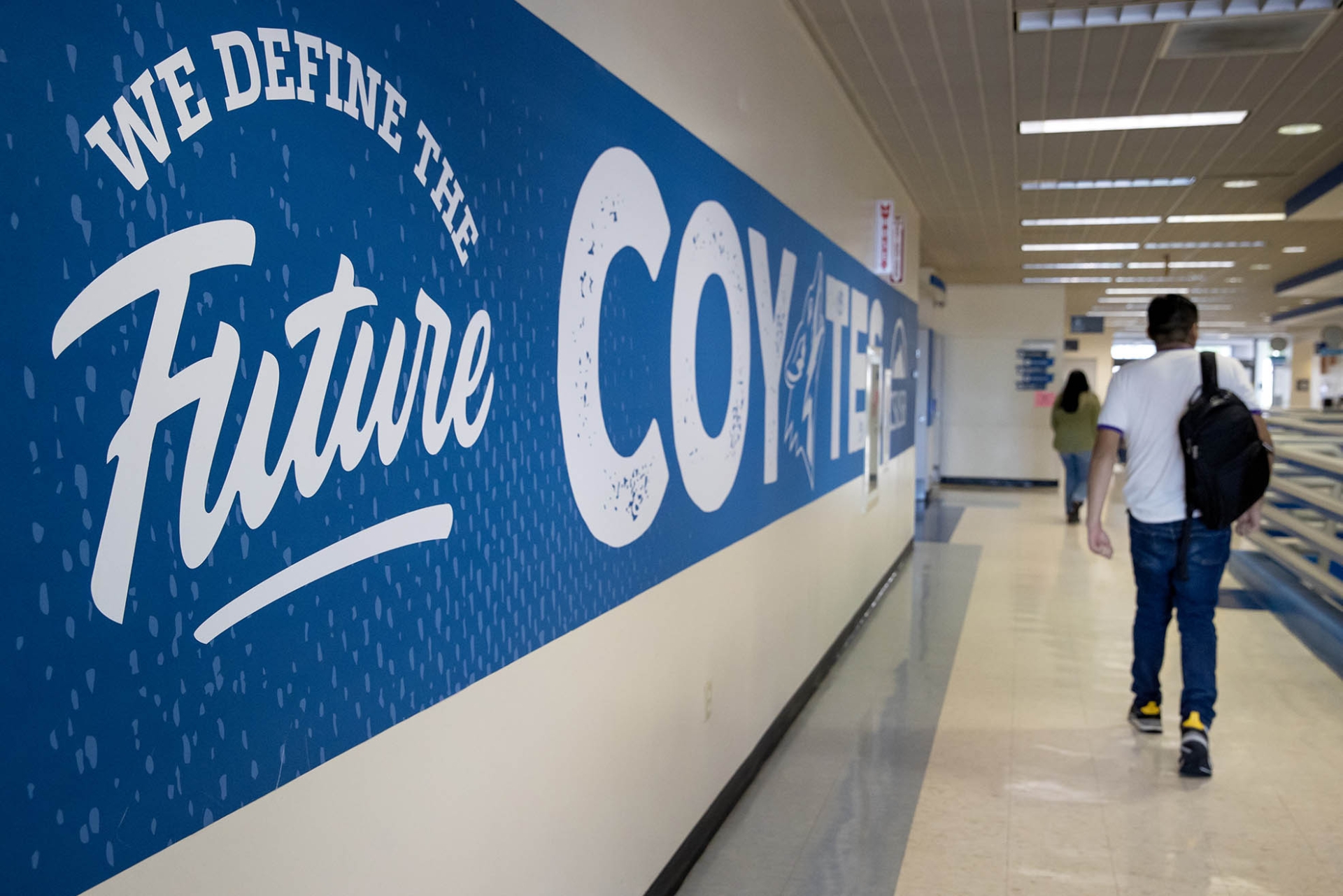 Scene in University Hall by the We Define the Future wall graphic