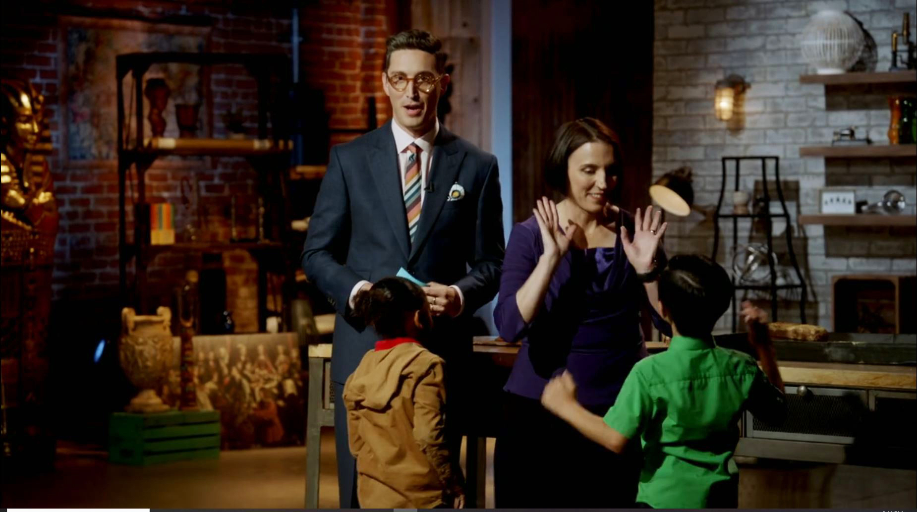 Buzzy Cohen, on left, host of “The Einstein Challenge,” and Kate Liszka with two members of the show’s 6-year-old panelists.