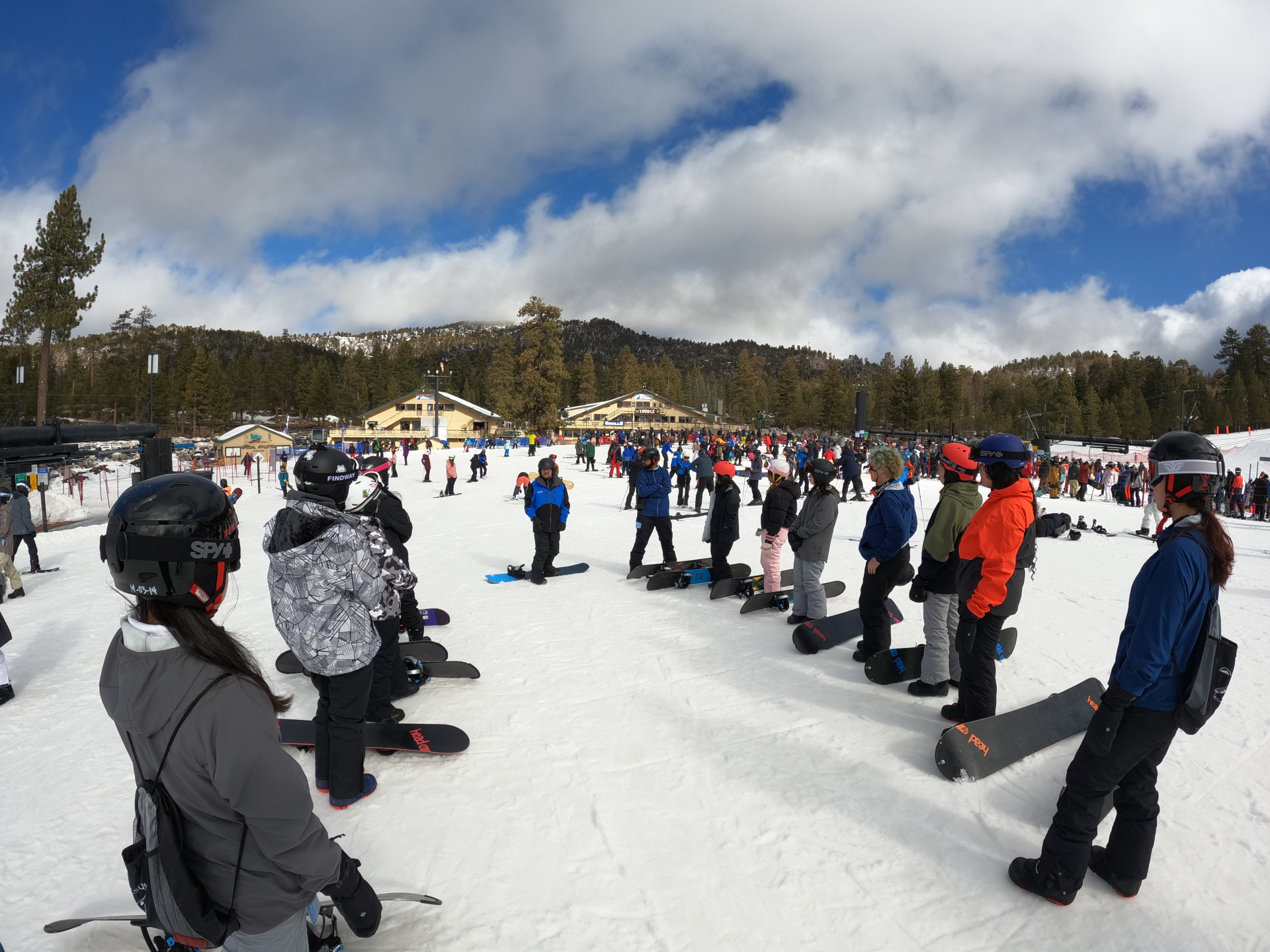 large crowd of people waiting for chair lifts