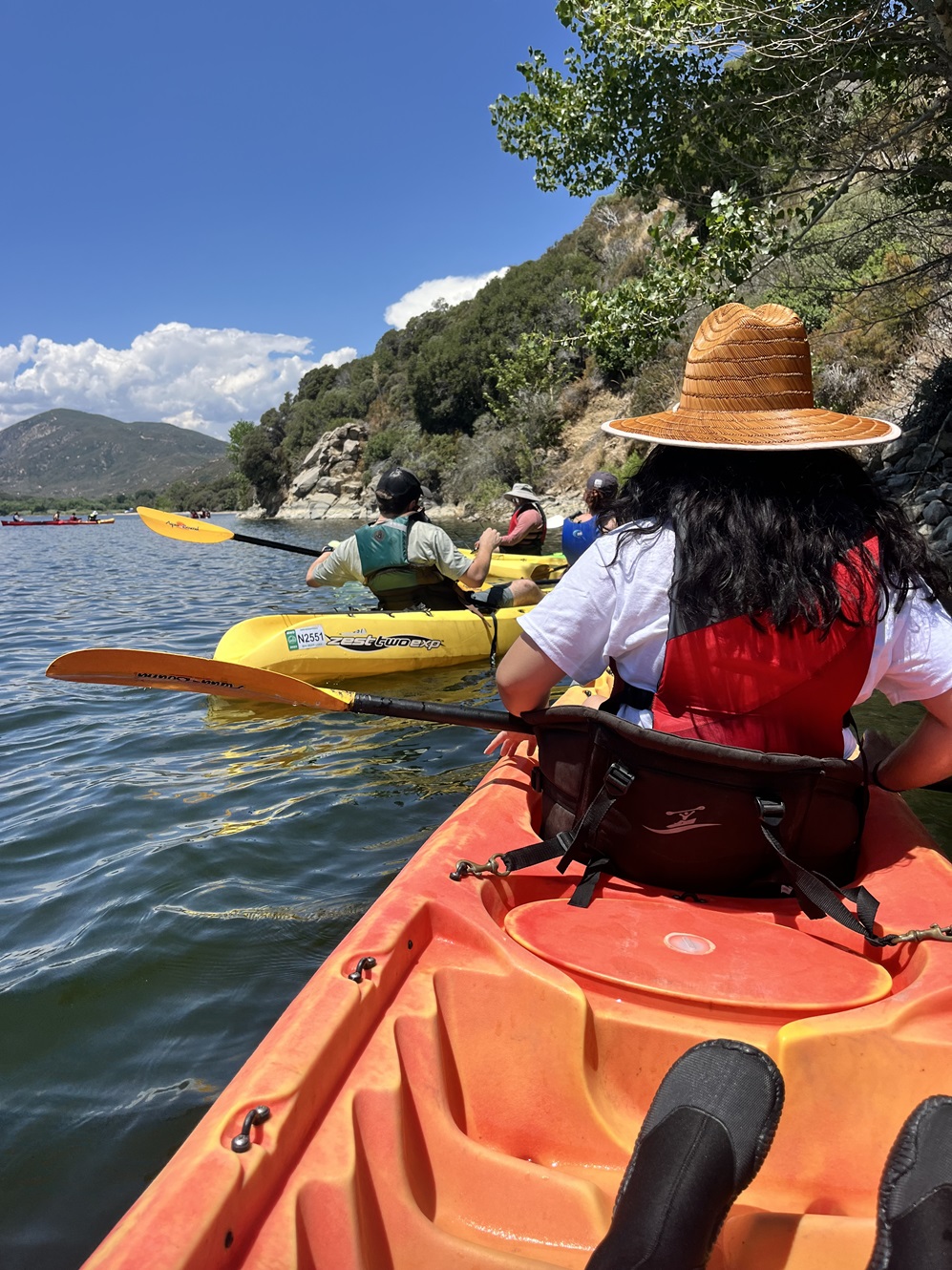 kayaker sitting in boat looking at hill