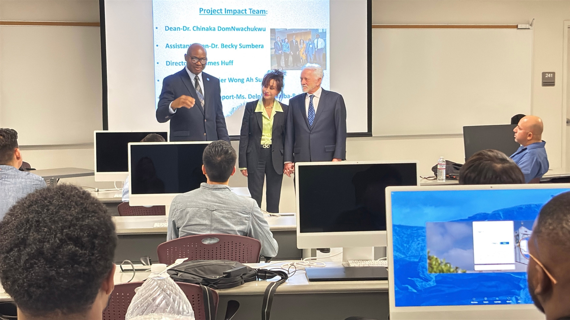 From left: Chinaka DomNwachukwu, dean of the James R. Watson and Judy Rodriguez Waston College of Education, Judy Rodriguez Watson and James R. Watson, at a meeting of Project Impact students and faculty in February 2025, the day a PBS crew visited to film for its segment, “Project Impact: Diversifying the Teacher Workforce.”