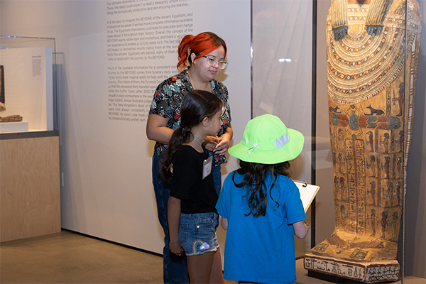 Children gaze at Egyptian art.