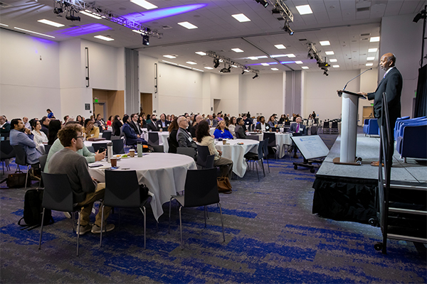 Sam Sudhakar, CSUSB vice president and chief financial officer (far right), speaks to the audience at the 2025 PROPEL AI Symposium.