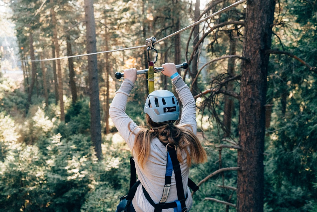 a person ziplining through trees