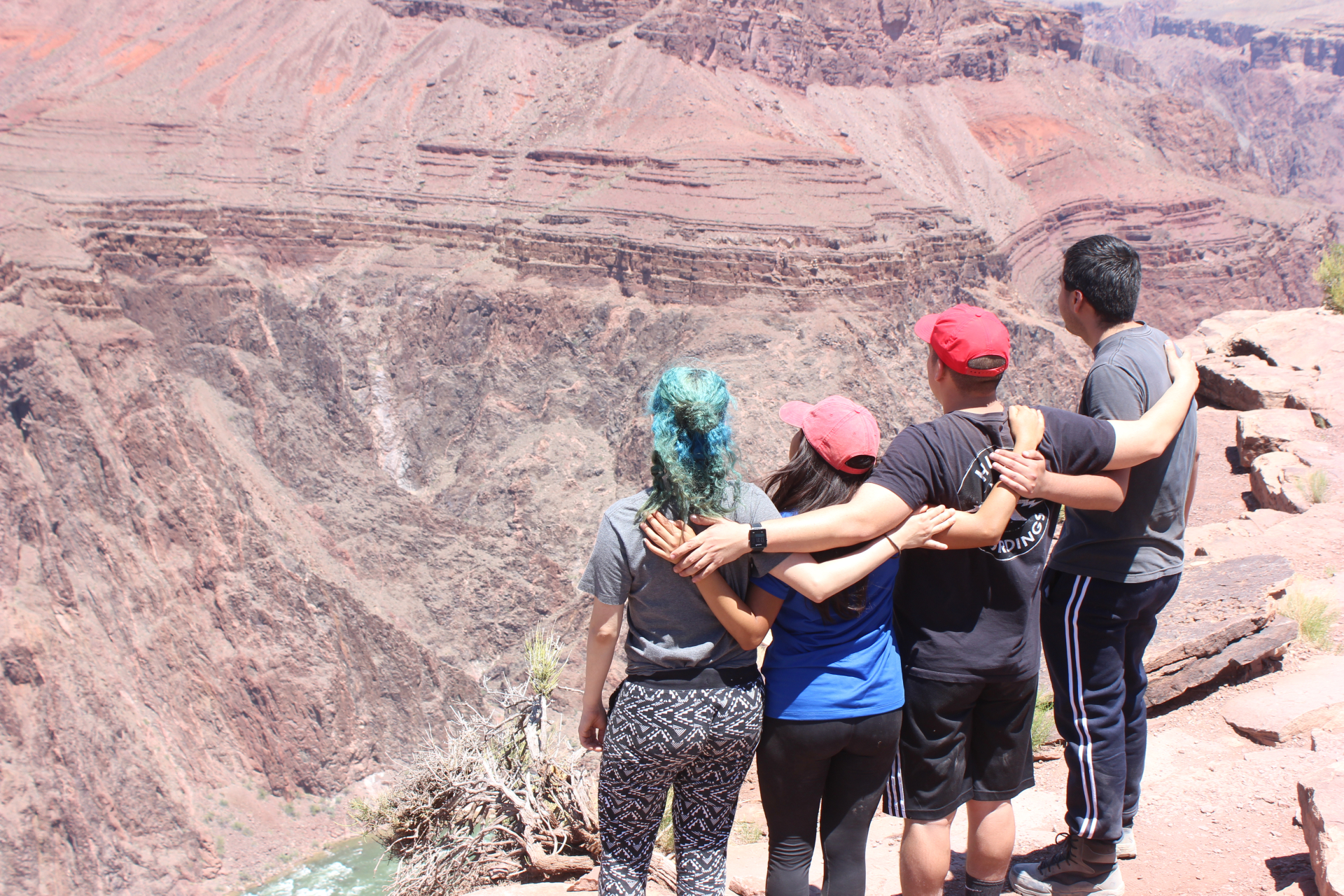 Group with Arms on shoulers looking at canyon