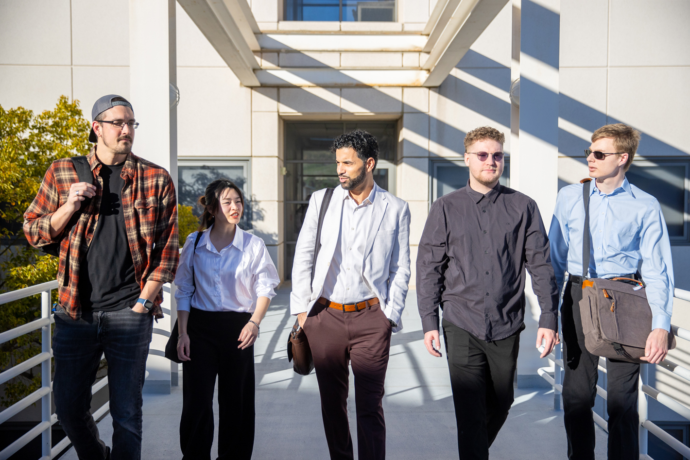 Associate Professor Bilal Khan, center, has integrated his students directly into the research process, giving them experience that mirrors professional and applied research environments.