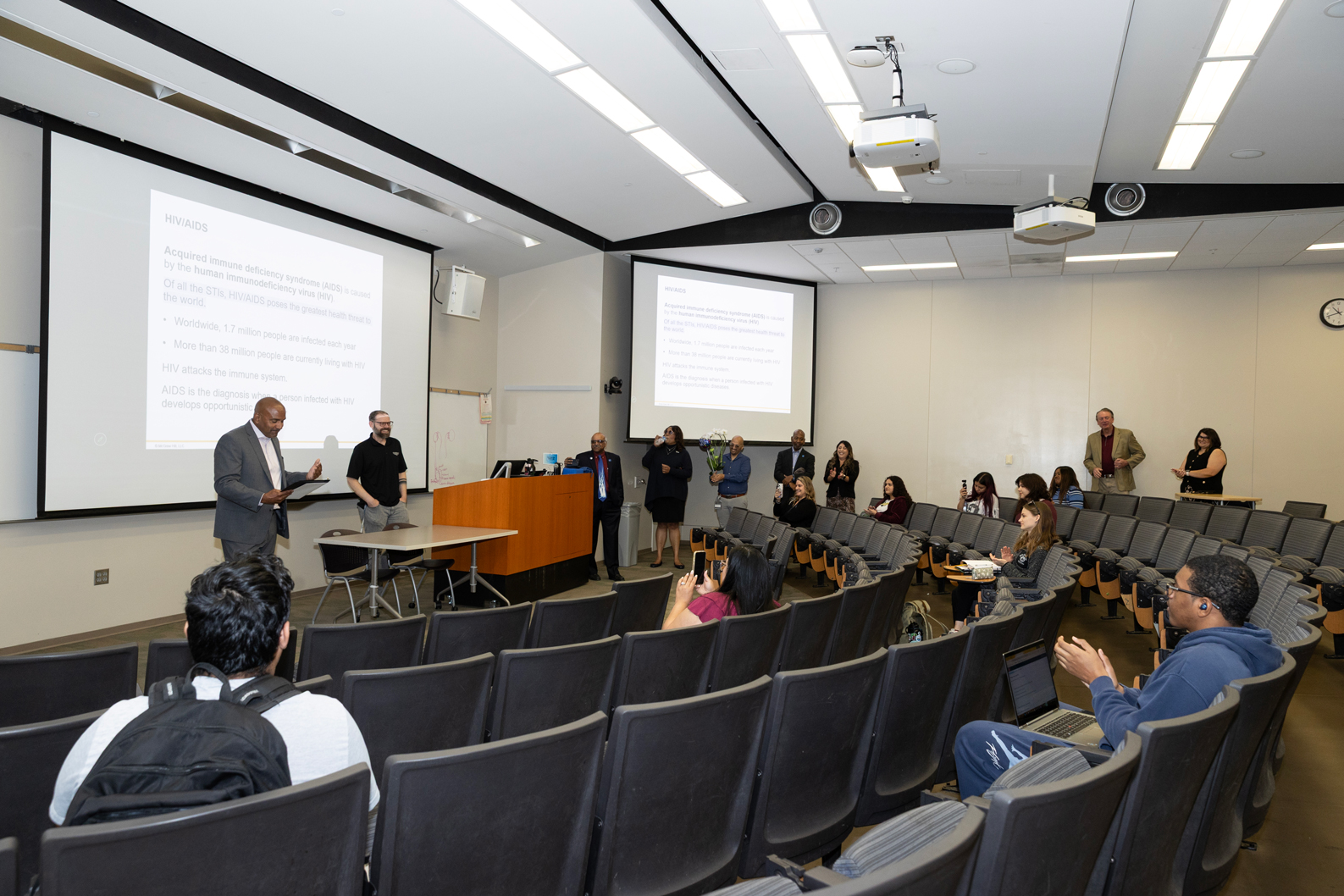 Nathaniel Bodell, associate professor of kinesiology, was surprised during his Monday morning class with the Golden Apple Award presentation.