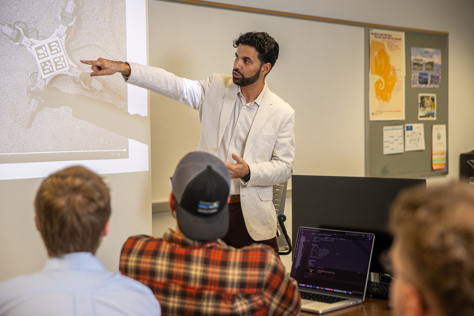 Khan delivering a lecture about artificial intelligence and technology. 