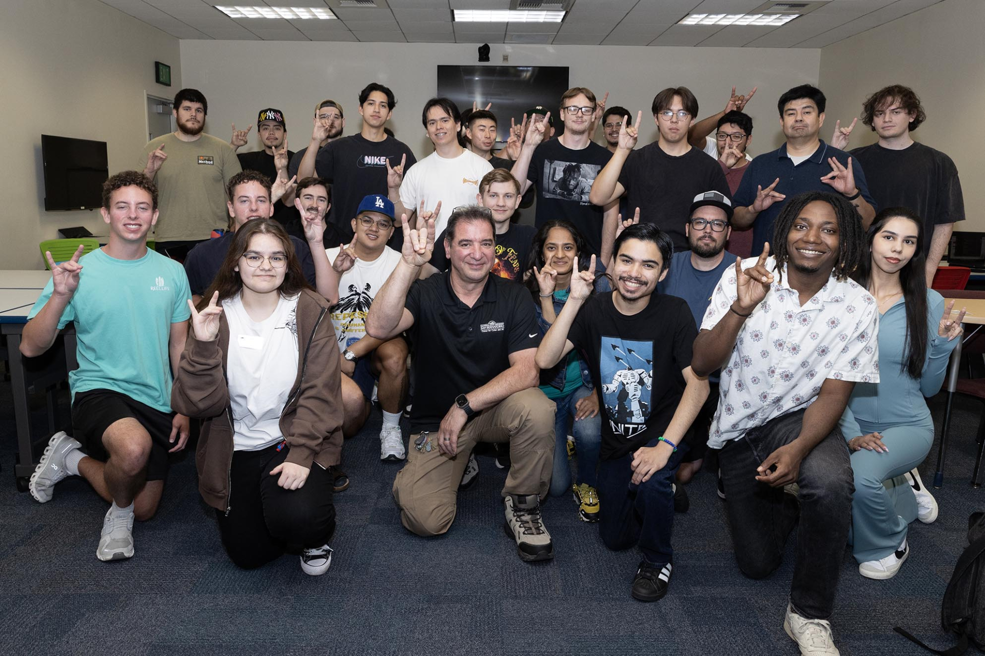 Vincent Nestler (center) is surrounded by his students after he was named the recipient of the 2026 Outstanding Professor Award.