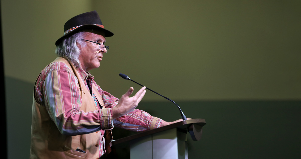 James V. Fenelon speaking at podium